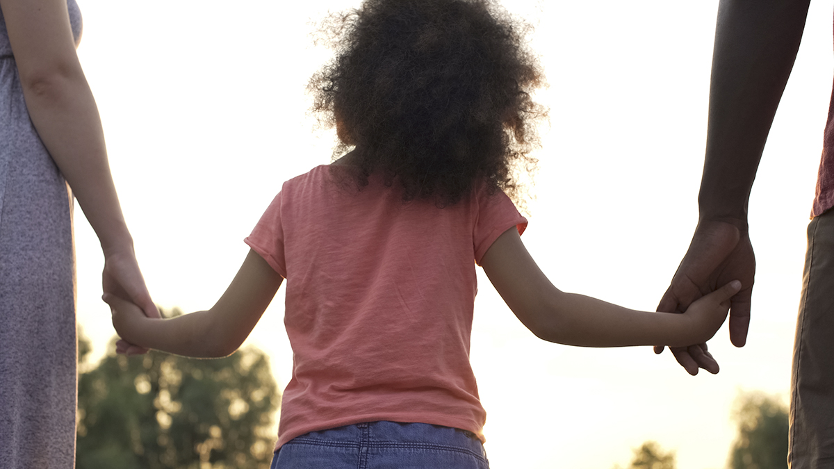 Little girl walking with family