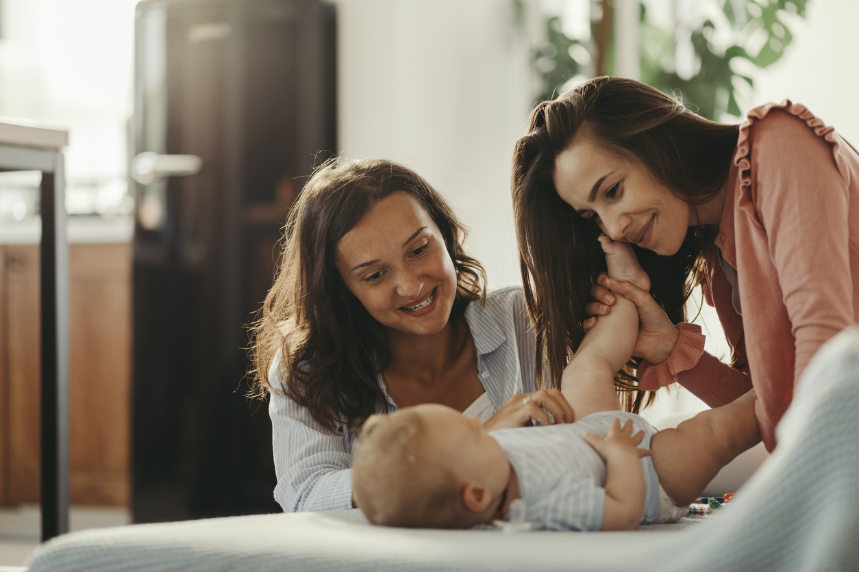 Two women looking at baby