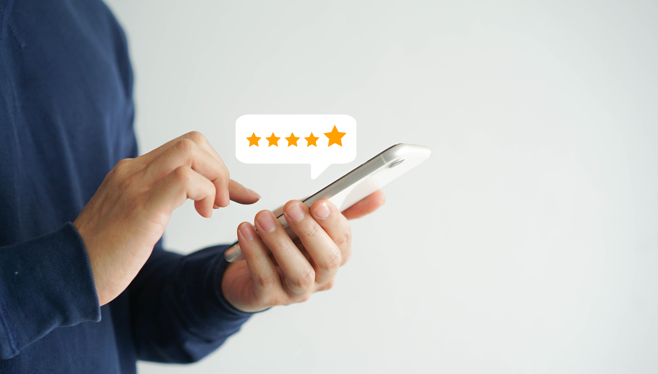 Woman giving 5-star review on phone
