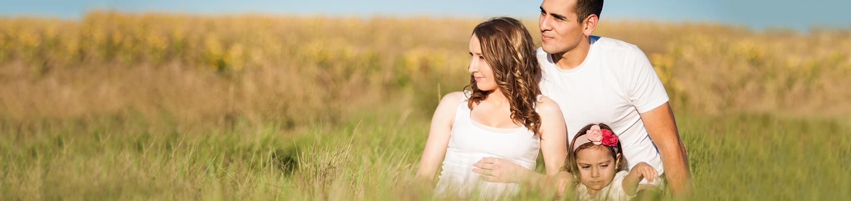 Mom, Dad and child in field