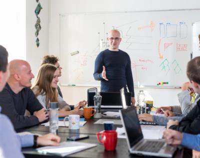 Group of coworkers sitting around a table in a training about bias