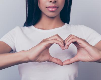 Girl making heart shape with her hands