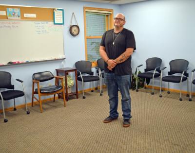 Joshua Grondahl standing in a group therapy group room