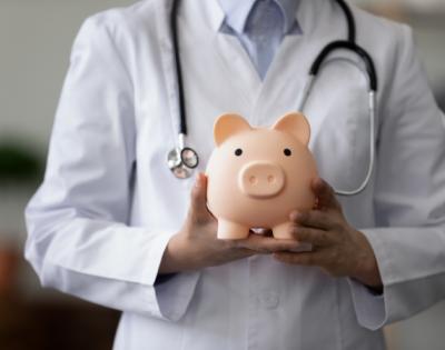 doctor holding a piggy bank