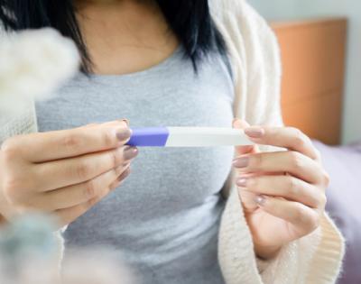 Woman holding pregnancy test