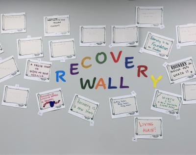First Step Recovery wall covered in slogan submissions surrounding the words Recovery Wall