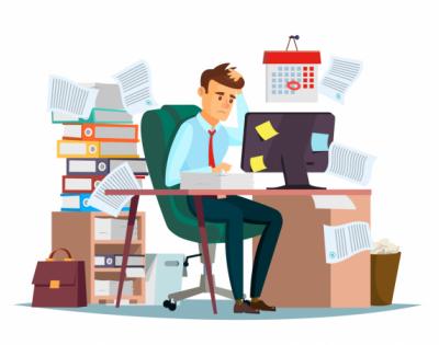 Man sitting at work desk with piles of papers around him looking very stressed
