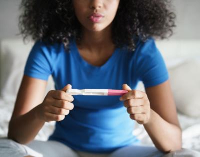 Teenager holding pregnancy test