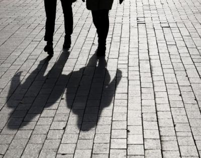 the shadows of two people walking together