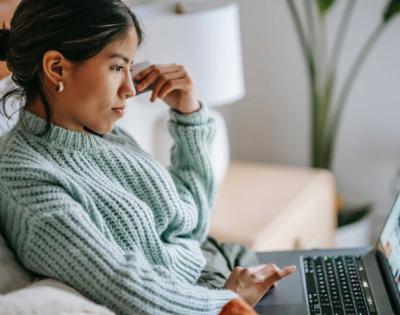 Girl staring at a computer online shopping.