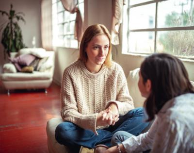 Woman talking to young teen girl
