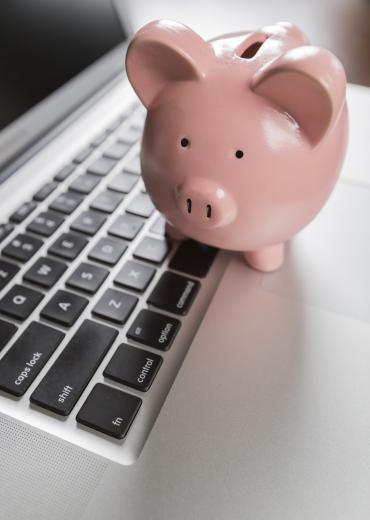 Piggy bank on laptop keyboard
