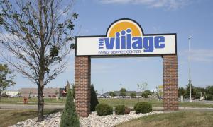 Signage for The Village office on the corner of 25th Street and 12th Avenue South