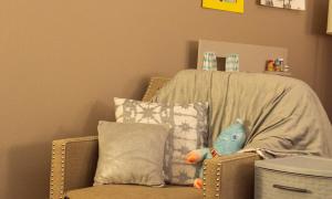 A basket of toys next to a cozy chair in a therapist's office