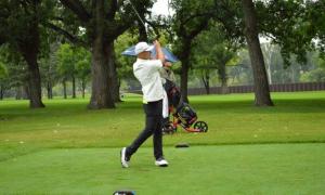 Golfer watches his ball soar