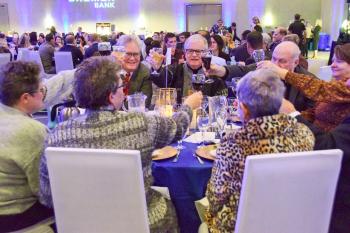 Guests clink glasses at Wine and Dine