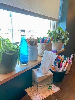 Markers, colored pencils and tissues line the windowsill