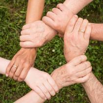 Hands clasp wrists to form a circle