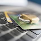Lock and credit cards laying on top of computer keyboard