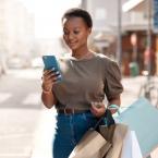 Woman with shopping bags looking at phone