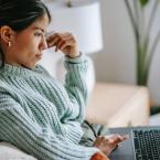 Girl staring at a computer online shopping.