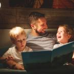 Dad reading a bedtime story to children before bed