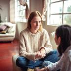 Woman talking to young teen girl