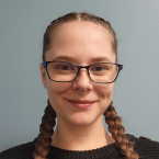 Headshot of Madalynn Fundine, a white woman with brunette hair in two braids