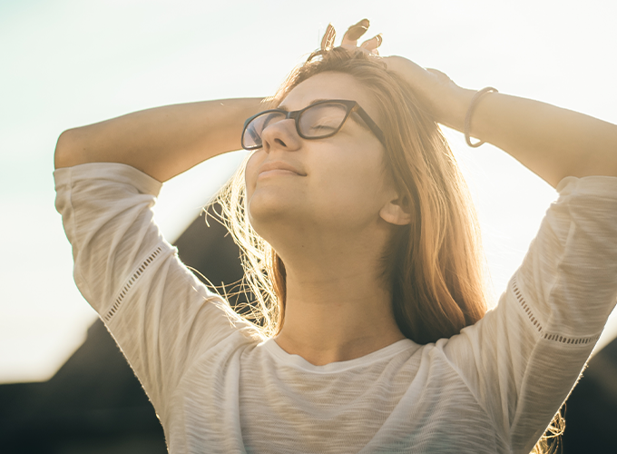 Woman with arms up, relaxed