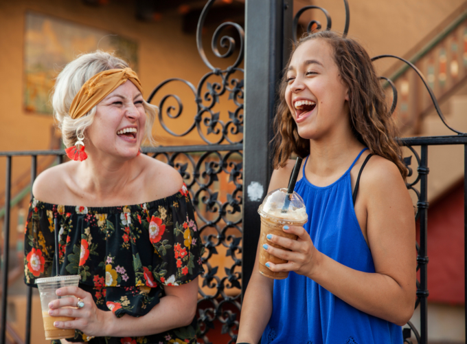 women and teenager drinking coffee smiling