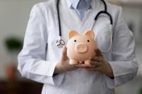 doctor holding a piggy bank