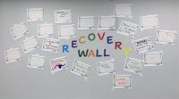 First Step Recovery wall covered in slogan submissions surrounding the words Recovery Wall