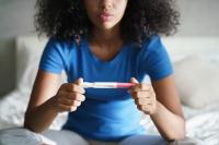 Teenager holding pregnancy test