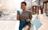 Woman with shopping bags looking at phone