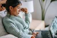 Girl staring at a computer online shopping.