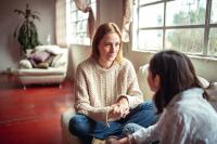 Woman talking to young teen girl